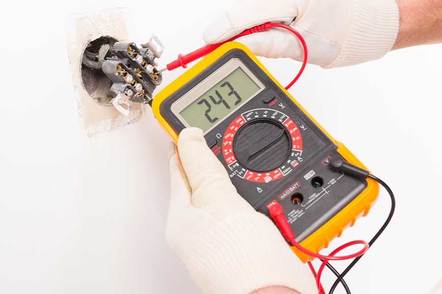 Electrician using a multimeter